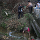 Puerto Rican residents collect water from a stream. Image via Getty.